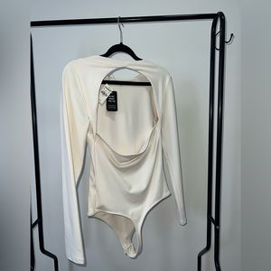 Brand new express thong body suit with open back